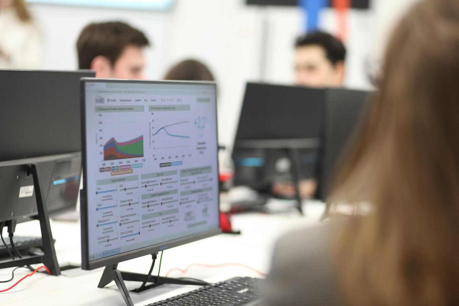 Analysts reviewing emissions data on screen